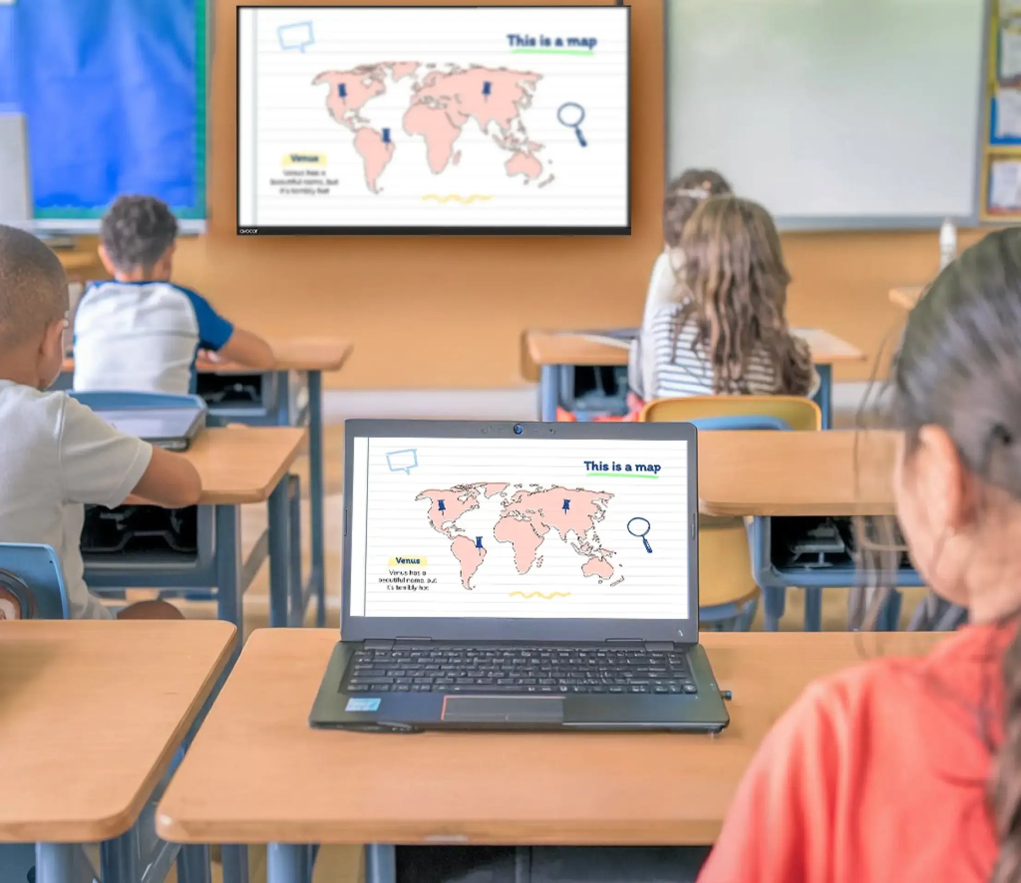 Students in a classroom viewing a shared screen on her laptop