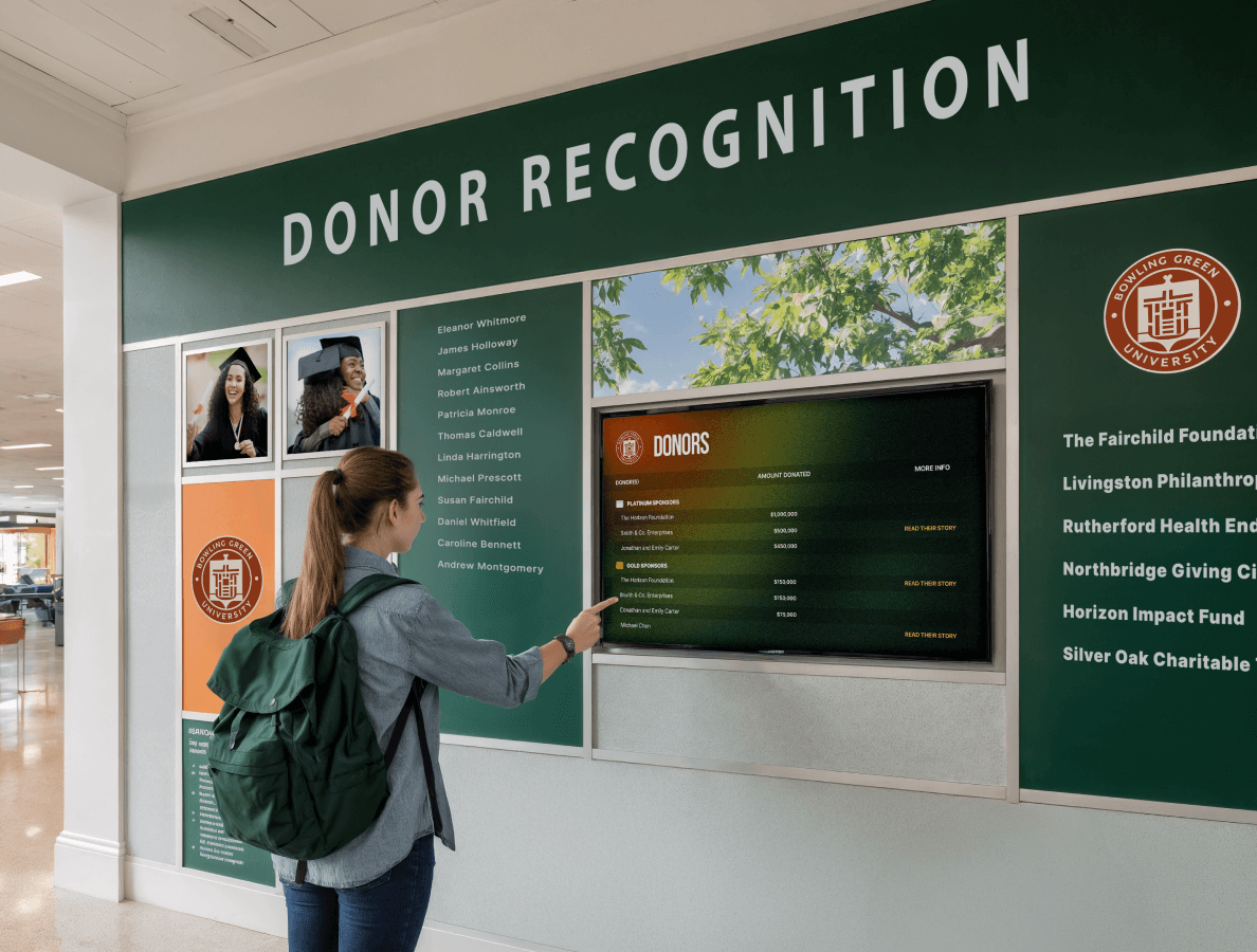 A female higher education student swiping on a digital donor recognition display