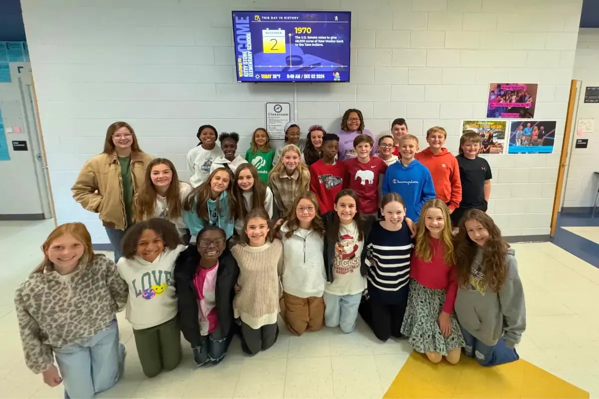 Jacksonville school students near a digital display
