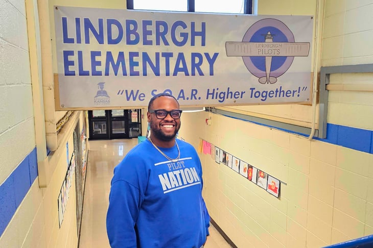 Dr. Wiley standing in front of a banner that says Lindbergh Elementary