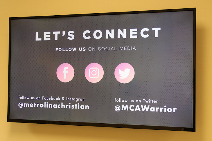 Metrolina Christian Academy announcing their school social media accounts on a digital signage display