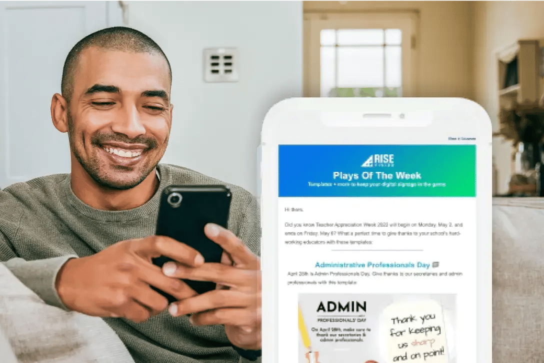 A man on a phone viewing the Rise Vision weekly recommendations for the latest on digital signage