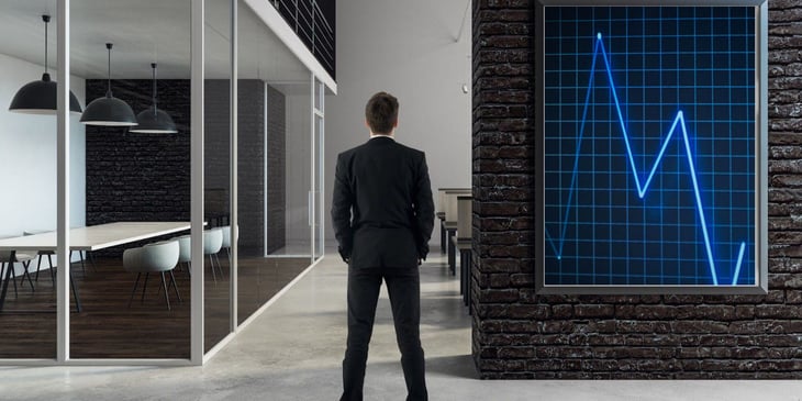 A man standing in front of digital signage installed in the office, promoting corporate social responsibility initiatives and fostering sustainability awareness.