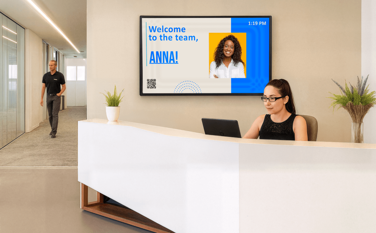 Office lobby with a welcome to the team message on a digital display