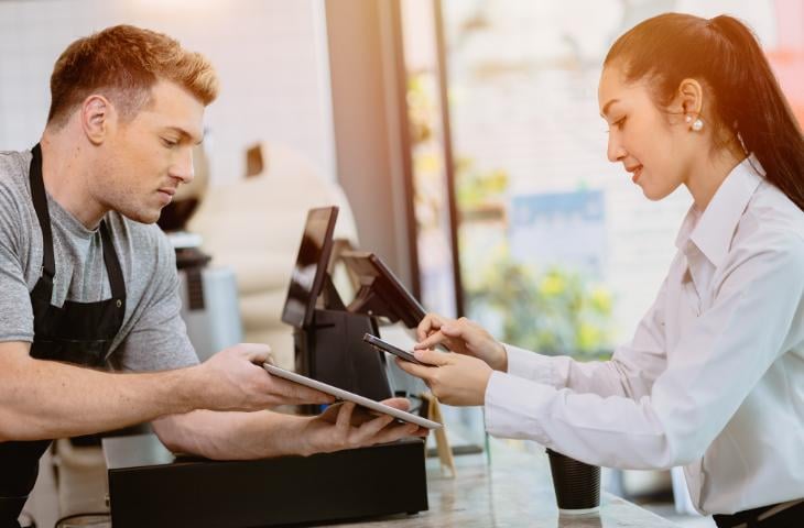 A woman paying with her phone.