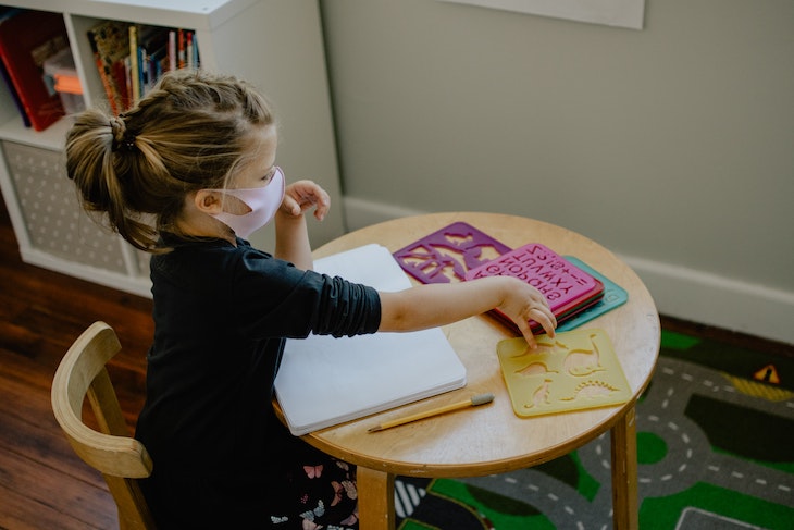 Student in classroom wearing a mask while learning.