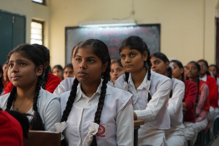 Students in classroom sitting and enjoying lesson