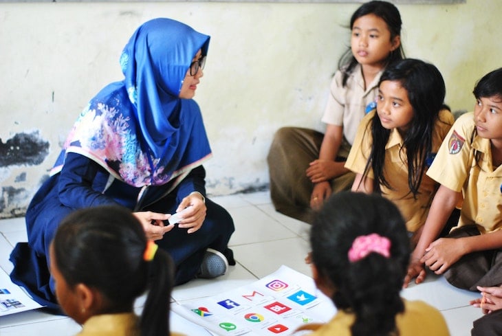 Students learning digital technology tools in a classroom