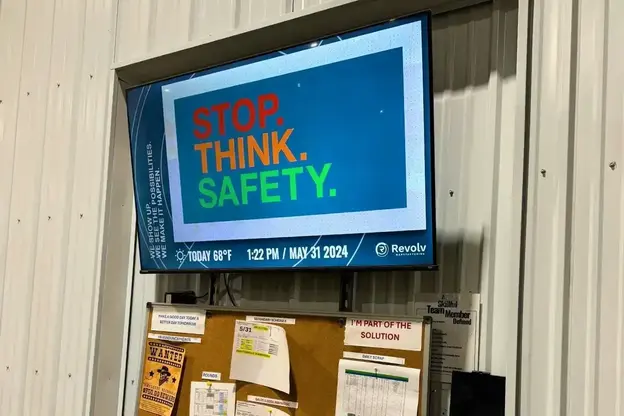 a digital signage display showing stop think safety