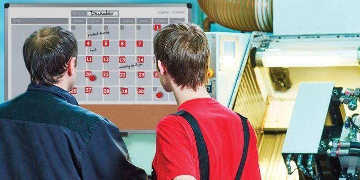 Two men looking at the safety scoreboard.