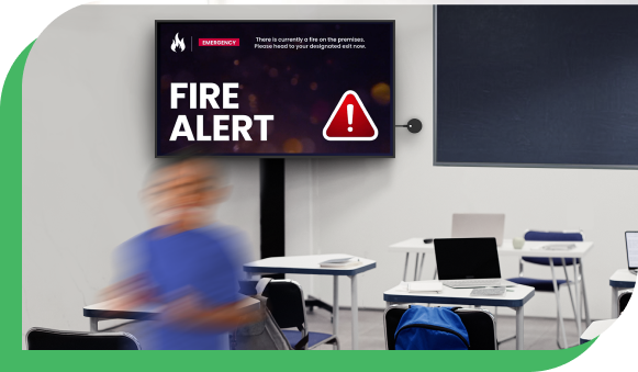 A TV in a classroom with an Airtame device connected to it showing an fire emergency alert.