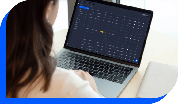 A woman looking at the Airtame Cloud digital signage software dashboard on her laptop.