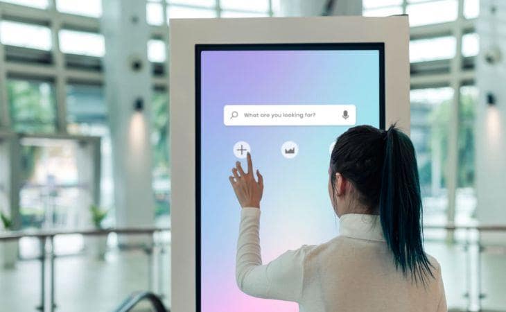A passenger using airport digital directories for an improved experience.