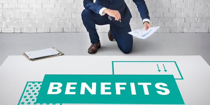 An employee kneeling, with benefits written on the floor.