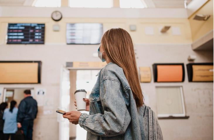 Woman looking at digital signage in a government office’s common area.
