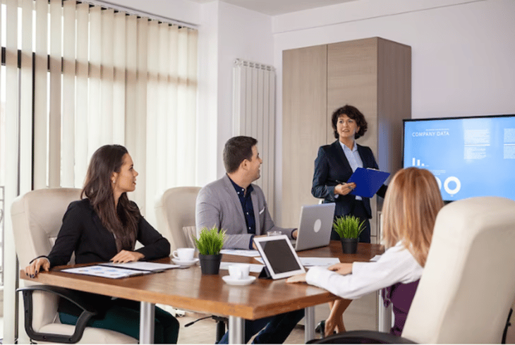 Office workers in a meeting about company performance.