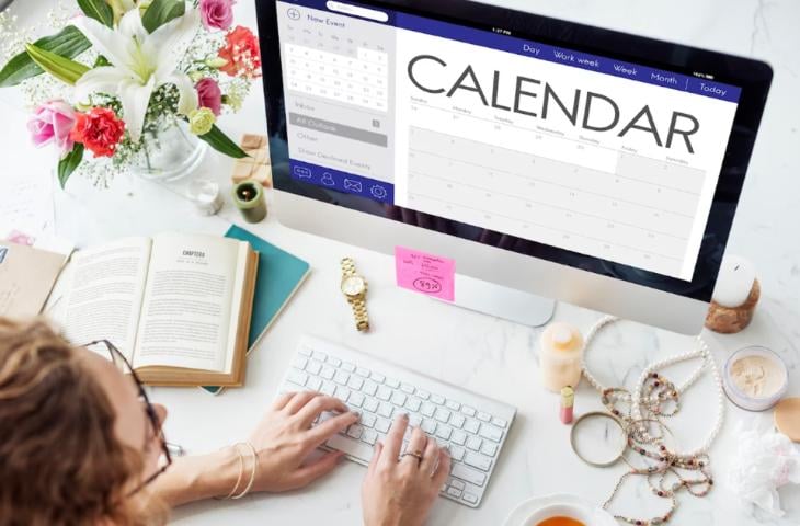 A women creating a content calendar on her computer.