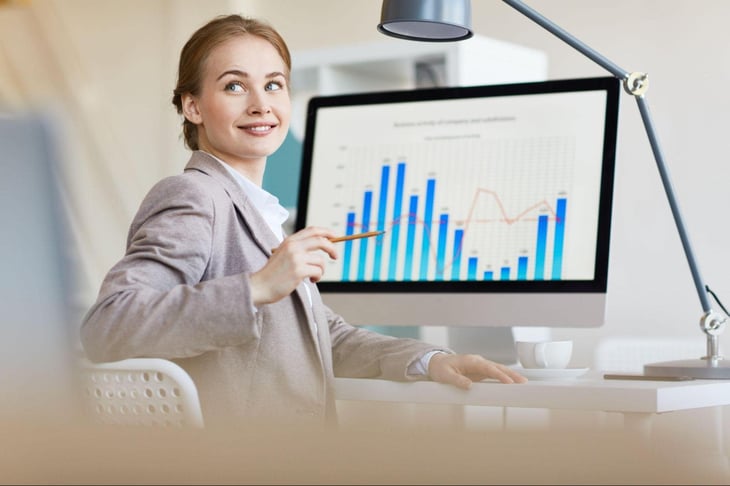 Office woman with data and analytics on her computer screen. 