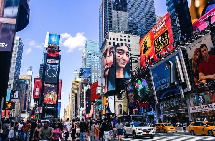 Digital signage billboards in a bustling city.