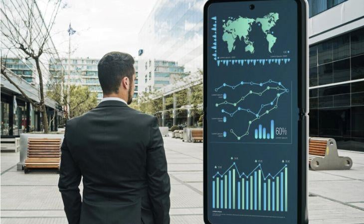 A man looking at a live dashboard on a digital signage screen.