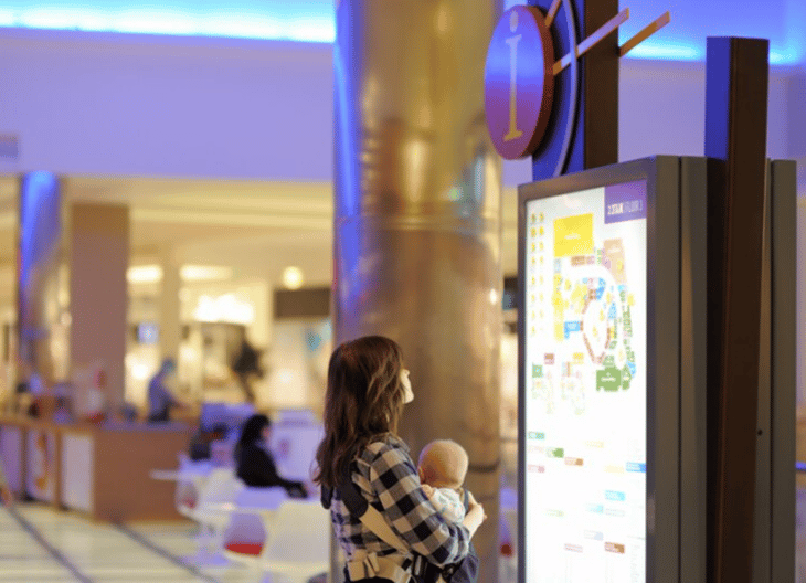 Woman looking at a map on a digital screen.
