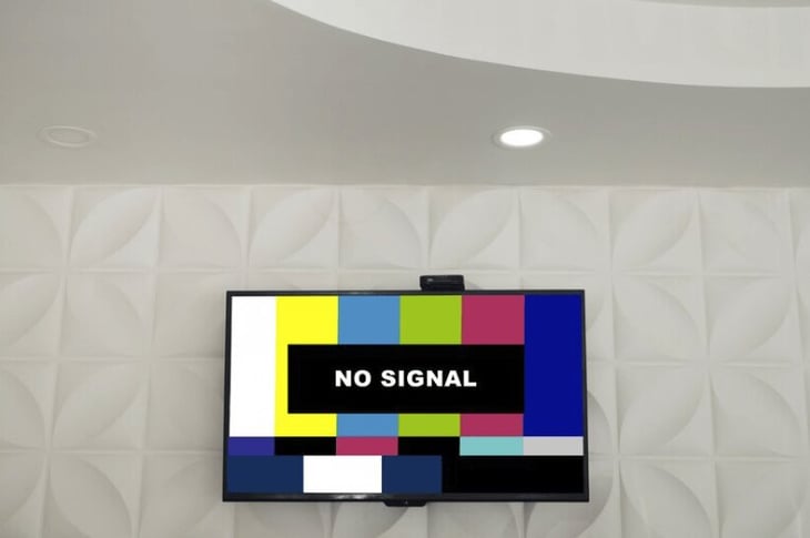 Digital signage TV mounted on a wall with no signal. 