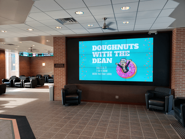 A video wall made up of nine displays in a three by three matrix showing content from a university.