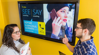 students in front of digital signage