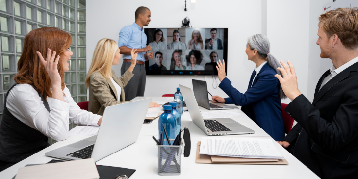 Five coworkers are having a meeting in a meeting room.