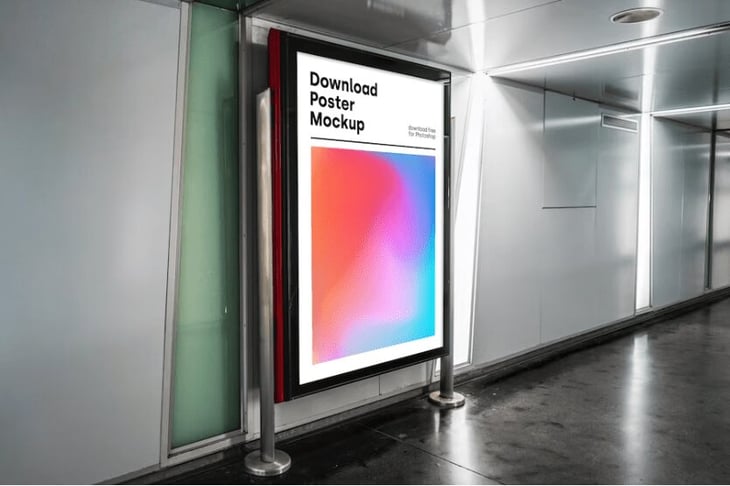 Digital signage along a hallway displaying a mockup design.