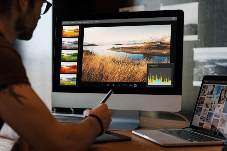 Designer editing a photo on computer software.