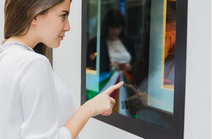 A woman interacting with an art exhibit.
