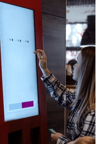 Girl interacting with a digital sign. 