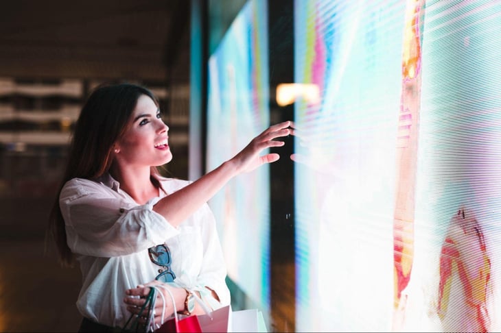Woman interacting with a digital sign.