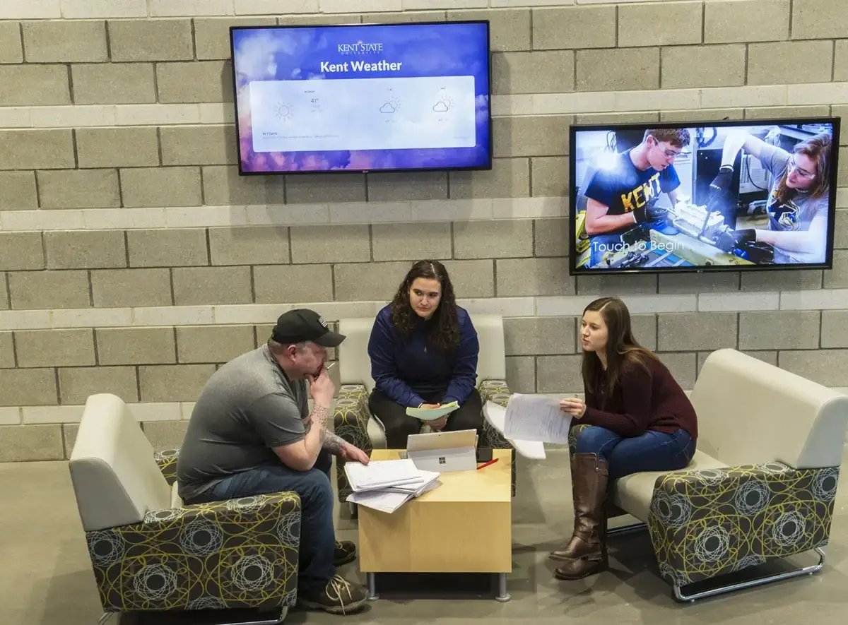 Kent State univeristy students sitting near digital displays