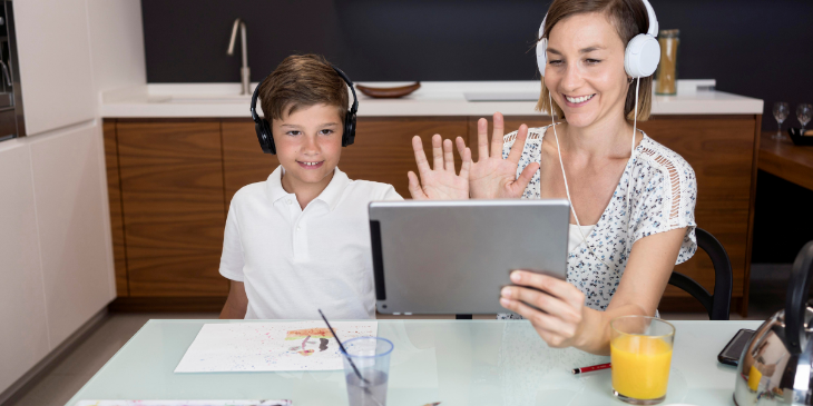 Kid is having fun with Teacher by using a digital signage tablet.