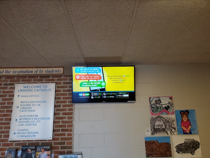 Digital signage at Lansing Catholic High School showing tips to be safe online 