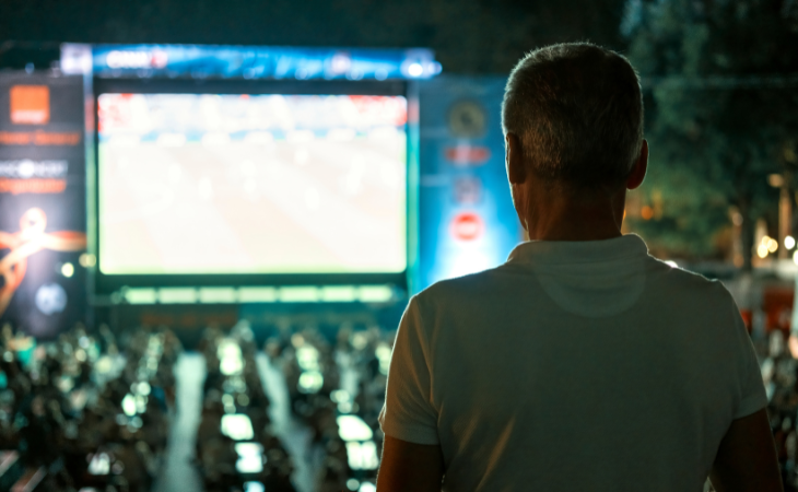 man looking at digital signage shown in public