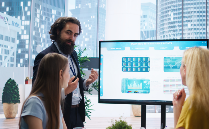man presenting report in front of team