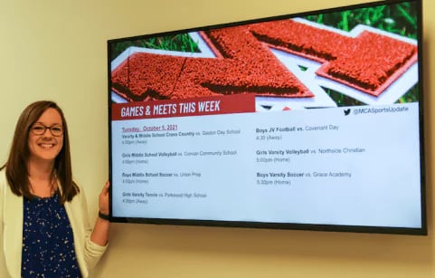 Lindsay Calloway in front of a digital sign.