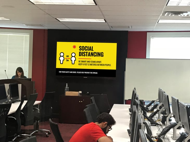 Social distancing digital signage in an office.