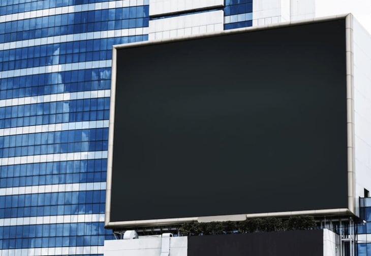 Large digital signage displayed in front of a building. 
