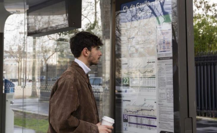 A man looking at a digital screen with an outdoor digital signage enclosure.