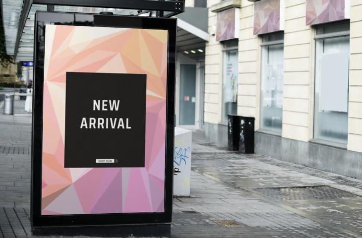 An outdoor digital signage screen installed at a bus stop.