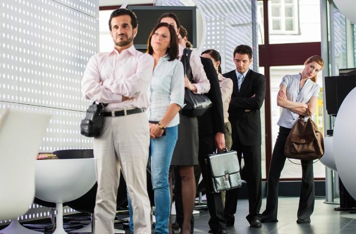 People waiting in line at a bank.