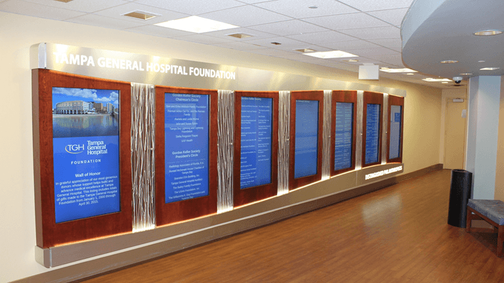 A series of portrait digital signs being used to show a donor wall.