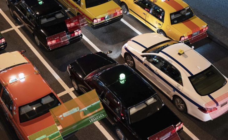 Cars on a road with their plate numbers highlighted.