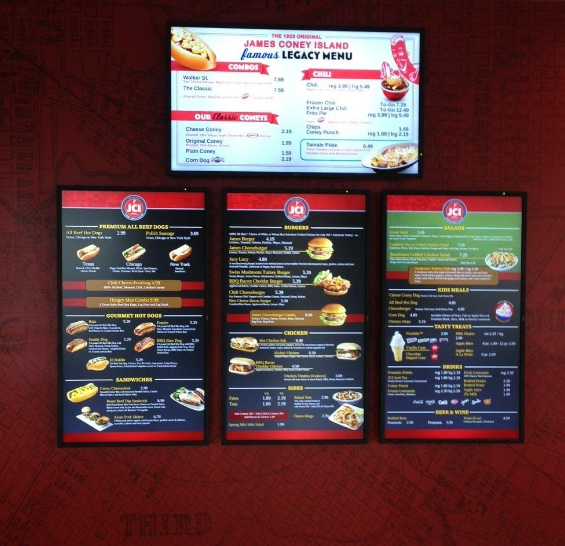 4 electronic bulletin board displays, 3 in portrait and 1 in landscape orientation showing food menu items