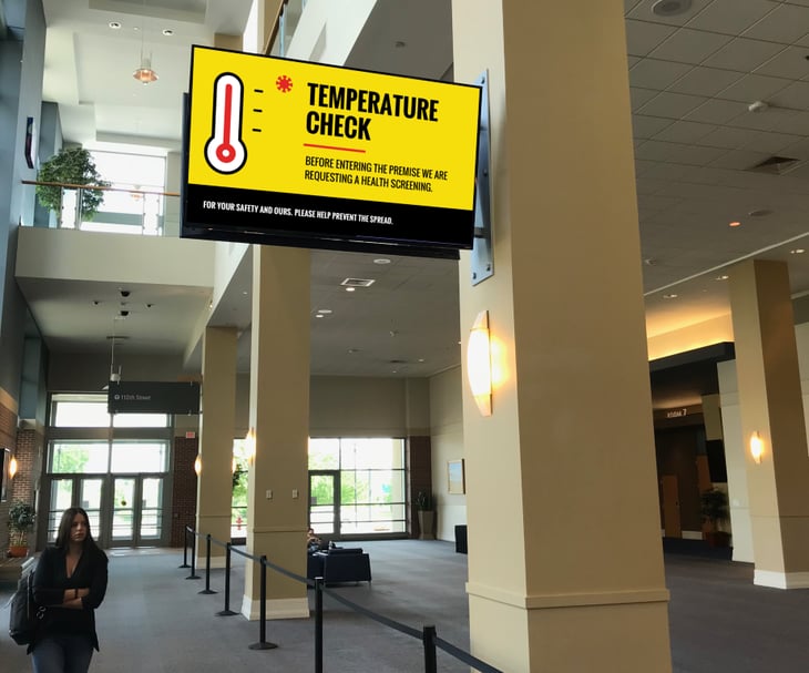 Temperature scanning information signage at a business