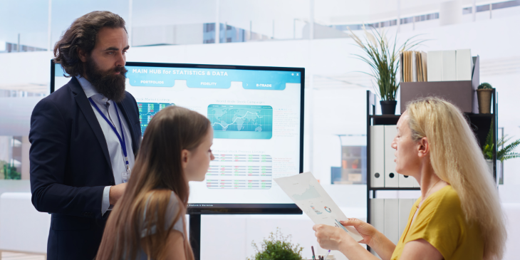 Three employees discussing in the IT office.